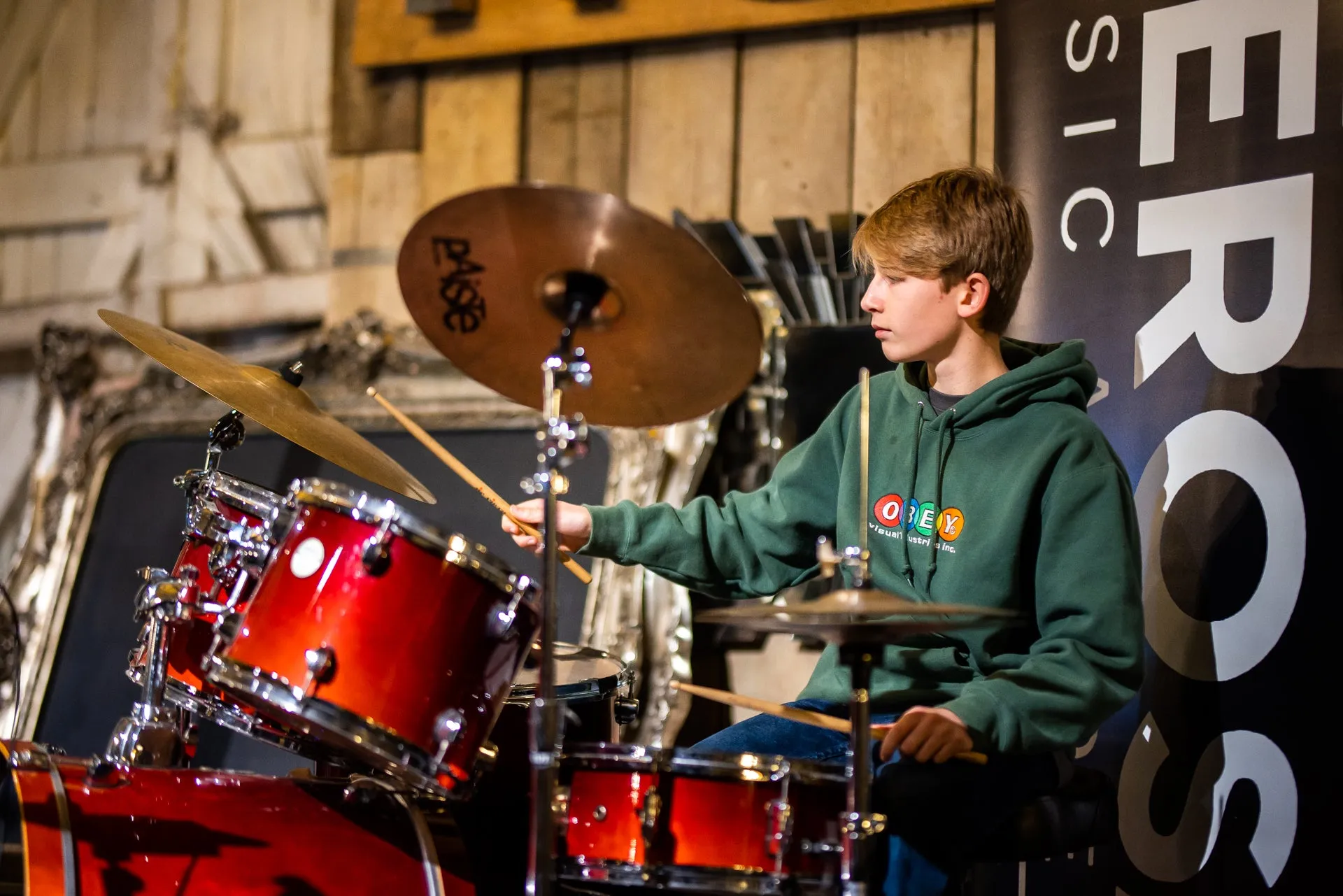 A DeRosa student playing drums at a performance